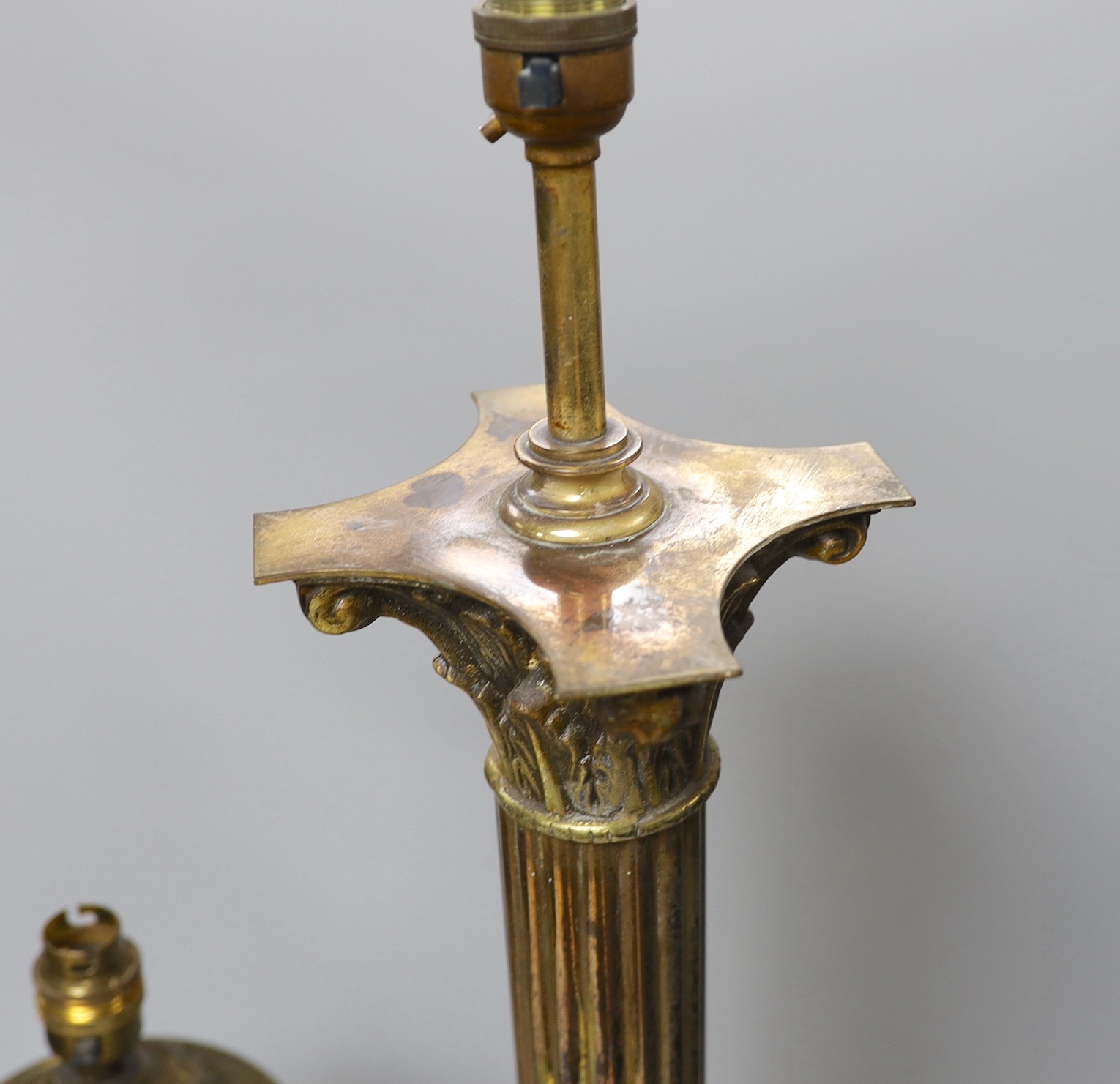 A Corinthian column lamp base and a two handled brass lamp base, tallest 60cms excluding light fitting